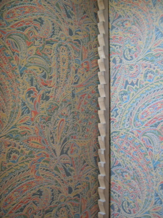 wallpapered cupboard interior